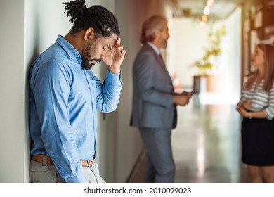 Male Worker Having Headache. Dark-haired Office Worker Having Headache After Been Fired From Work For No Reason. Stressed Employee Intern Suffering From Gender Discrimination Or Unfair Criticism.