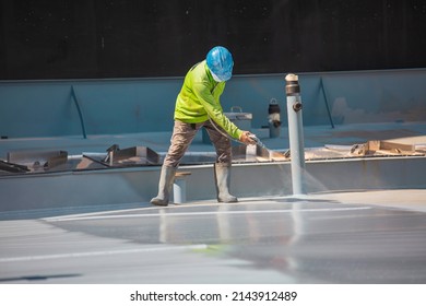 A Male Worker Holding An Industrial Spray Gun Used For Roof Plate Tank Surface On Steel Industrial Painting