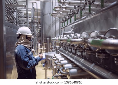 Male Worker Inspection The Process Of Food Drink At The Manufacturing Pipeline And Stainless Tank