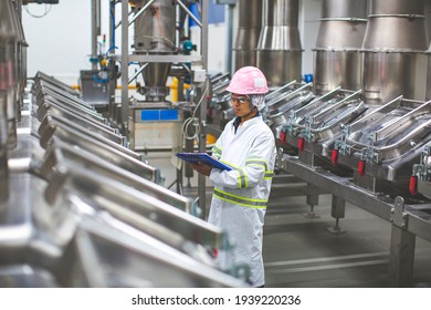 Male worker inspection the process of food drink at the manufacturing vertical factory and stainless tank. - Powered by Shutterstock