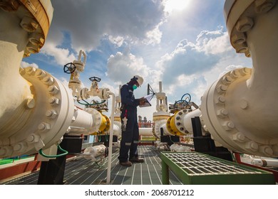 Male worker inspection at steel long pipes and pipe elbow in station oil factory during refinery valve of visual check record pipeline oil and gas industry. - Shutterstock ID 2068701212