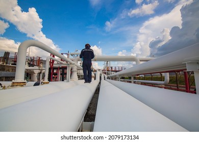 Male Worker Inspection At Steel Long Pipes And Pipe Elbow In Station Oil Factory During Refinery Valve Of Visual Check Record Pipeline Oil And Gas Industry.