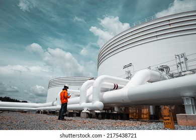 Male worker inspection at steel long pipes   pipe elbow in station oil factory during refinery valve visual check record pipeline tank oil   gas industry