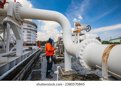 Male worker inspection at steel long pipes and pipe elbow in station oil factory during refinery valve of visual check record pipeline oil and gas industry - Powered by Shutterstock