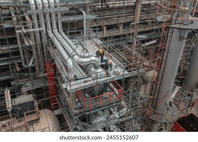 Male worker inspection at steel long pipes and pipe elbow in station oil factory heat exchanger during refinery valve of visual check record pipeline oil and gas