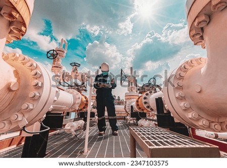Male worker inspection at steel long pipes and pipe elbow in station oil factory during refinery valve of visual check record pipeline tank oil and gas industry