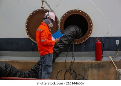 Male worker inspection the tank carbon chemical oil interface area confined space safety.