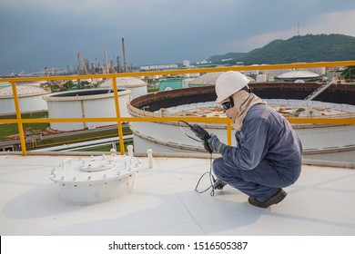 Male worker are for inspection  ultrasonic thickness roof plate top storage tank