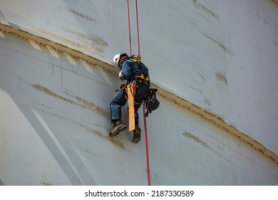 Male Worker Inspection Wearing Safety First Harness Rope Safety Line Working At A High Place On Tank Roof Spherical Gas Propane.