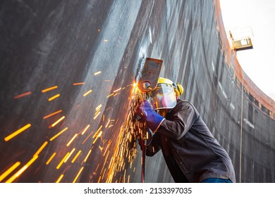 Male Worker Metal Cutting Spark On Tank Steel Plate With Flash Of Cutting Light Close Up Wear Protective Gloves And Mask