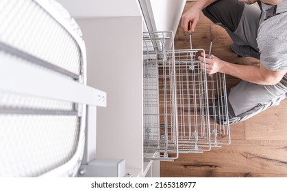 Male Worker Performing Closet Installation And Shelf Assembly While Providing His Services Of A Professional Handyman For A Variety Of Household Tasks.