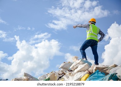 Male worker succeeds in working at a recycling plant. Supervising work to dispose and recycle waste at a waste recycling plant that is a waste recycling business. - Shutterstock ID 2195218879