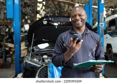 male worker talking on smartphone with customer in garage - Powered by Shutterstock