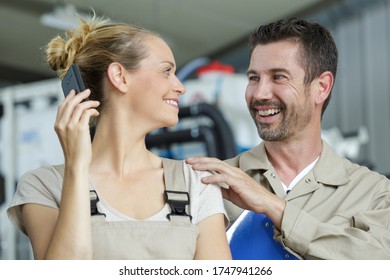 Male Worker Tapping Female Colleague On The Shoulder