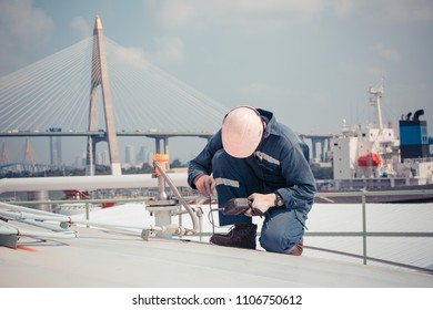 Male worker are ultrasonic thickness roof of  storage tank for inspection background the bridge