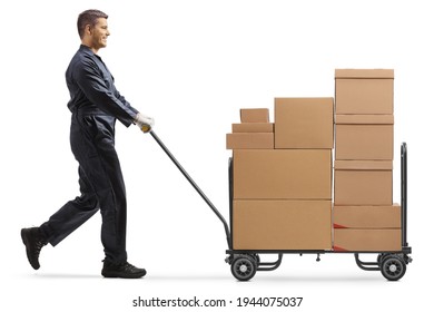 Male worker in a uniform pushing a hand truck loaded with boxes isolated on white background - Powered by Shutterstock