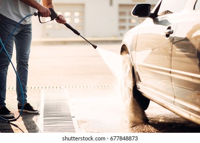 Male Worker Wash The Car With High Pressure Washer