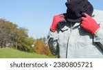 A male worker wearing a neck gaiter.Warm gear for cold days.