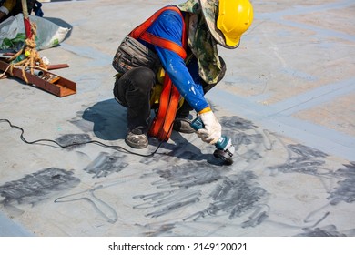 Male Worker Wearing Protective Clothing Cleaning Roof Oil Storage Tank Industrial Construction