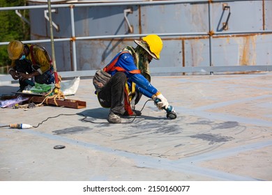 Male Worker Wearing Protective Clothing Cleaning Roof Oil Storage Tank Industrial Construction