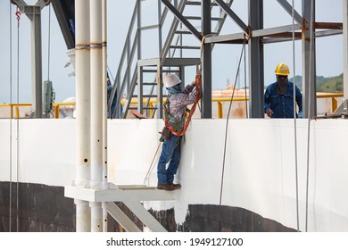 Male Worker Wearing Safety First Harness And Safety Lone Working At High Scaffold Place On Top Tank Roof Oil