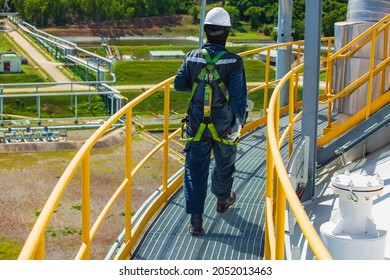 Male Worker Wearing Safety First Harness And Safety Lone Working At High Handrail Place On Open Top Tank Roof Oil