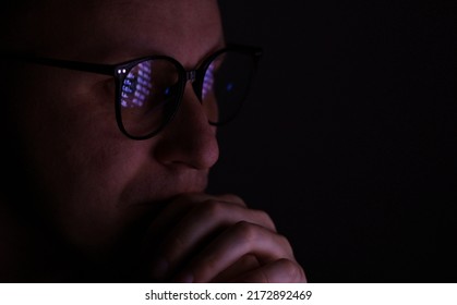 Male Working Online Late. Close Up Side View Of Focused Man Wears Computer Glasses For Reducing Eye Strain Blurred Vision Looking At Pc Screen With Computer Reflection Using Internet, Watching.