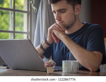 male writer working on laptop as digital nomad typing his first novel  with notepad and coffee - Shutterstock ID 1122867776