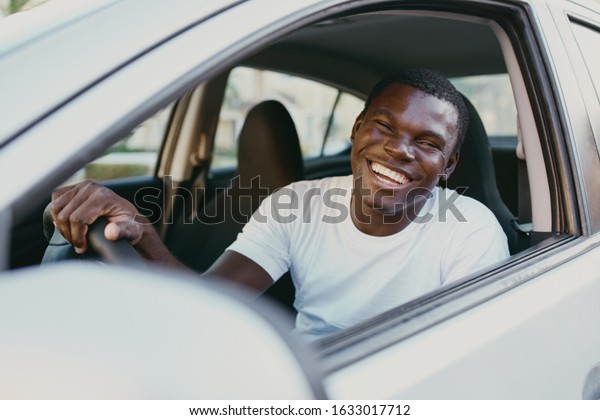 male young african\
american rides in car