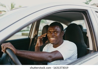 male young african american in white t-shirt sitting in car - Shutterstock ID 1631373019