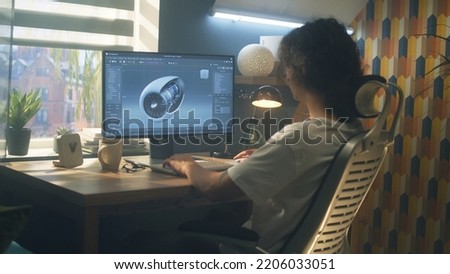 Male young engineer using pc with professional program and creating 3D prototype of airplane turbine while working remotely at home office