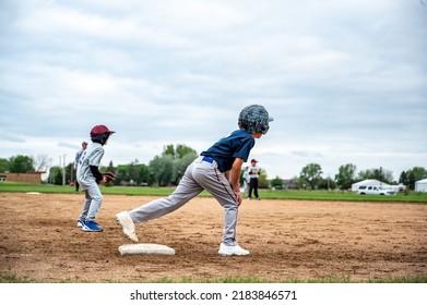 Male youth prepared to run to home base with one foot on and one foot off.. - Powered by Shutterstock