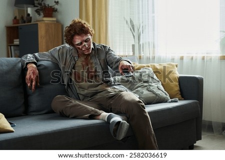 Male Zombie Using Remote Control
