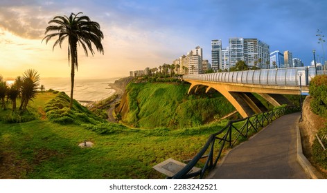 Malecon and Eduardo Villena Rey Bridge in Miraflores district on Pacific ocean coast in Lima city downtown, Peru, South America, in dramatic sunset light