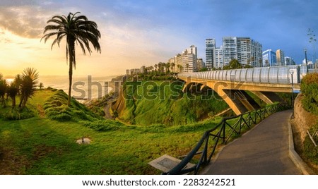 Malecon and Eduardo Villena Rey Bridge in Miraflores district on Pacific ocean coast in Lima city downtown, Peru, South America, in dramatic sunset light