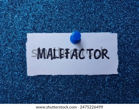 Malefactor writting on table background.
