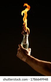 Male's hand with a burning Molotov cocktail isolated on black background. Concept photography about protests and war - Shutterstock ID 1786649948