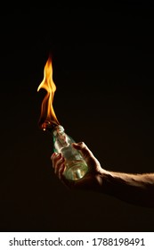 Male's hand with a burning Molotov cocktail isolated on black background. Concept photography about protests and war - Shutterstock ID 1788198491
