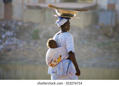 MALI, MOPTI, DECEMBER 28: Unidentified Woman Carrying A Baby In Her Back In The Streets Of Mopti. 2010