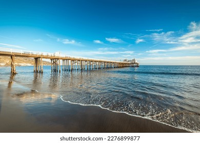 Malibu pier under a blue sky at sunset. California, USA