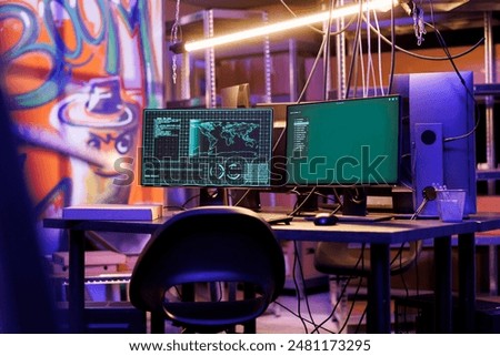Malicious software on computer screen hacking server in abandoned warehouse at night time. Ransomware stealing information and breaking into database on monitor in hackers hideout
