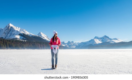 Maligne Lake, Canada - December 2020 : View Of Young Woman Holding A Baby Onesie 