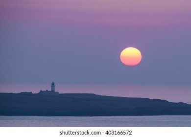 MALIN BEG, IRELAND - MARCH 17, 2016: Sunset Over Rathlin O'Birne Island Lighthouse.