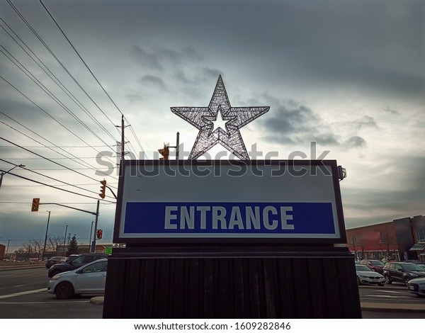 Mall entrance with christmas star with black spot\
for name.