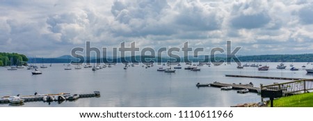 Mallets Bay on Lake Champlain, with many sailboats moored with the Green Mountains of Vermont across the lake