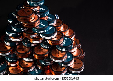 Malmo - Sweden September 27 2019: A pile of snuff cans In different brands and colors like Caliber and General, Snus is addictive and very expensive
