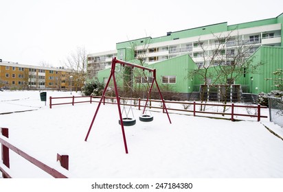 MALMO, SWEDEN-FEBRUARY 19, 2008: Children Playground Covered By Snow With Building Houses Project In The Background, In Malmo.