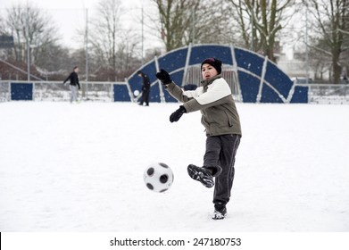 MALMO, SWEDEN-FEBRUARY 20, 2008: Children Playing Soccer In A Playground Covered By Snow, In Malmo.