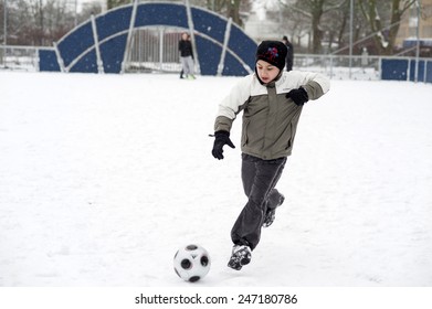 MALMO, SWEDEN-FEBRUARY 20, 2008: Children Playing Soccer In A Playground Covered By Snow, In Malmo.