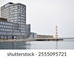 Malmo University building reflected in water.